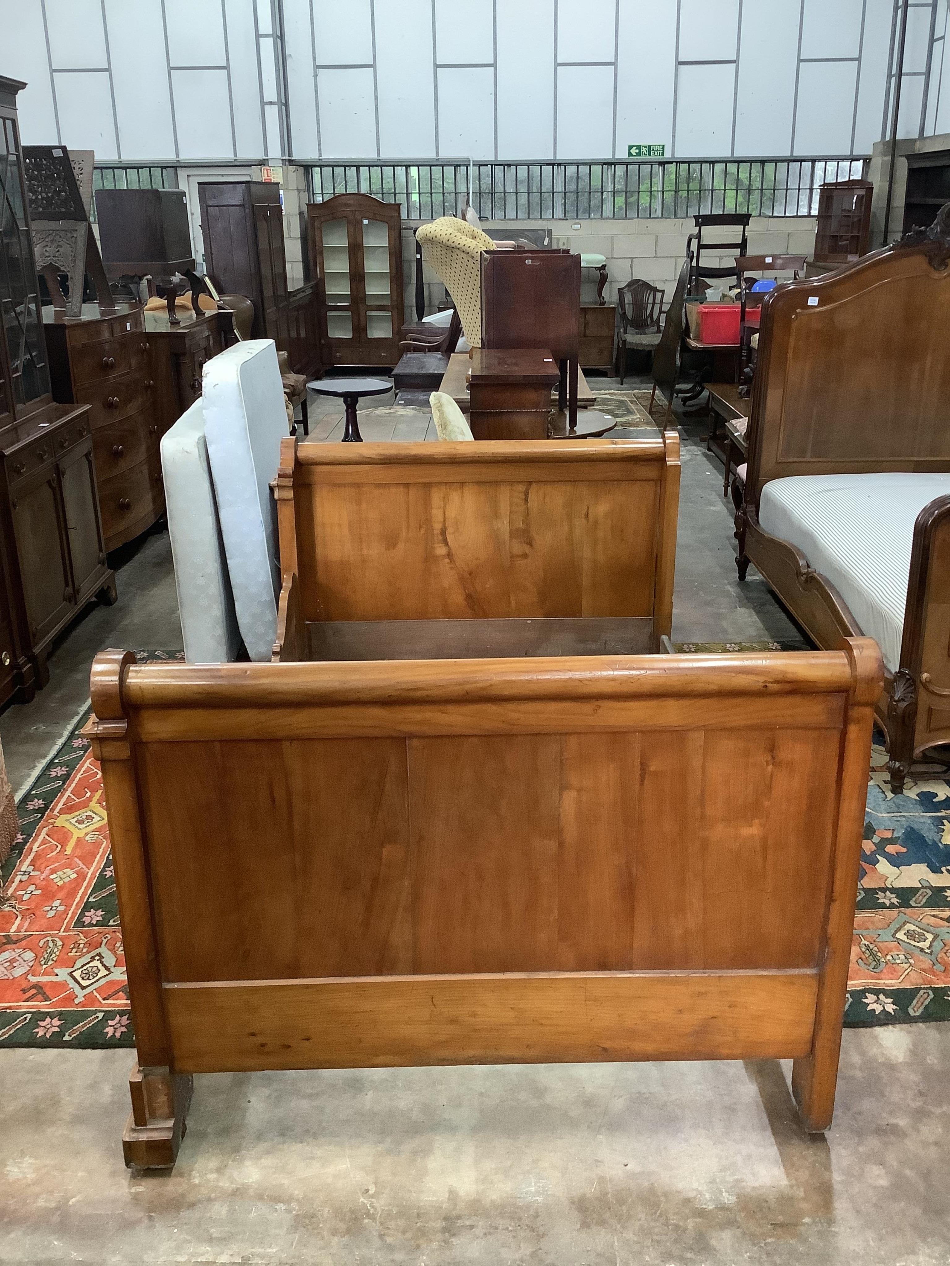 A 19th century French carved walnut sleigh bed, width 130cm, length 202cm, height 100cm. Condition - fair